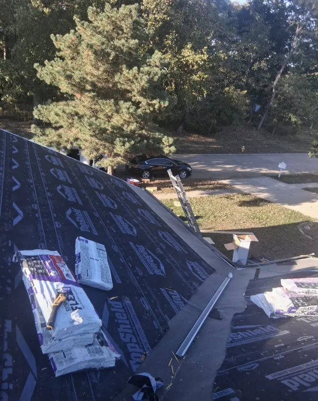 Underlayment and roofing materials staged near a roof valley at the Foxpoint Drive project in Maryland Heights